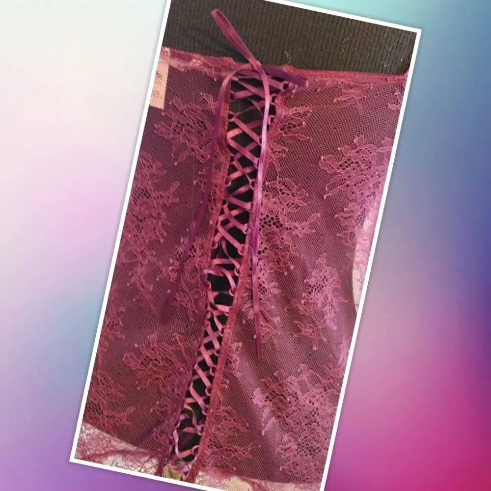 Victoria Secret XS maroon lace top. Features lace tie on the back, gold accent